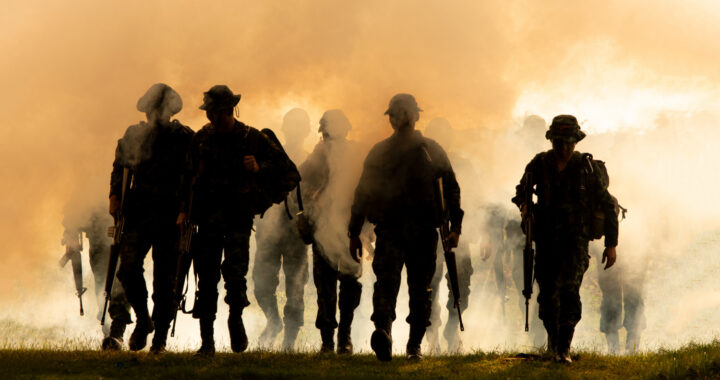 silhouette-unrecognized-soldiers-with-rifle-walk-through-smoke