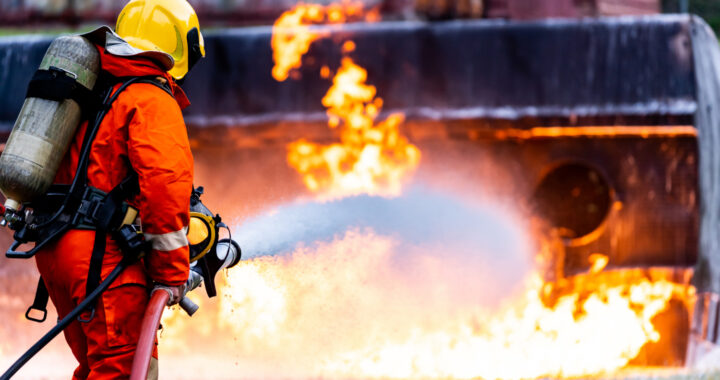 firefighter-spraying-down-fire-from-oil-tanker-truck-accident